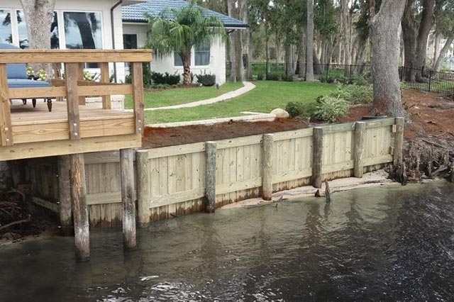 A home protected by a seawall connected to a dock