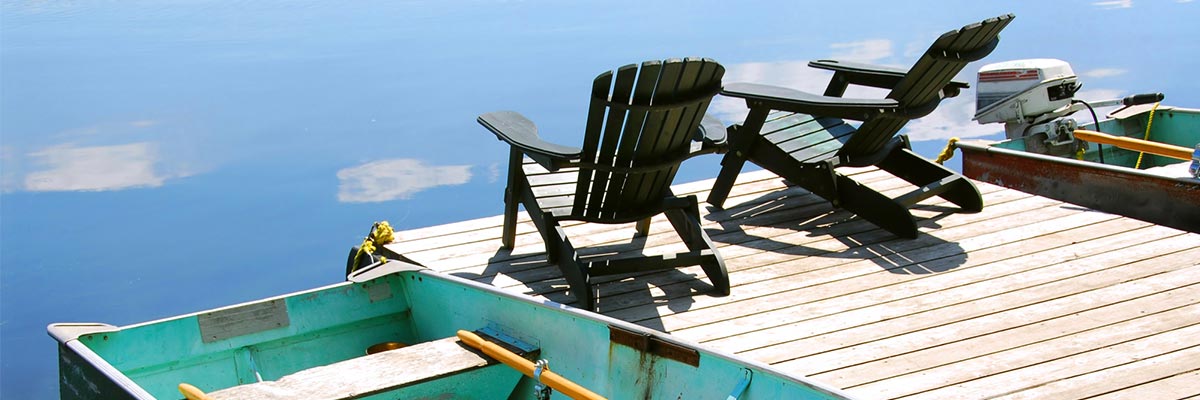 Lounge chairs on a dock with row boats