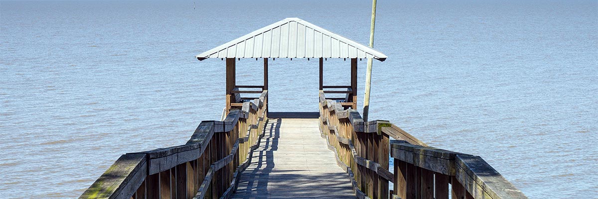 Sunny day at a lake dock with a pavilion